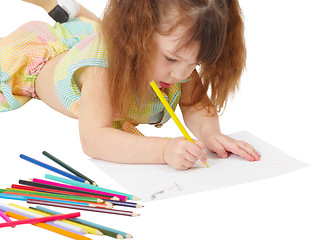 Image showing Child draws a picture with colored pencils