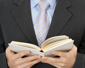 Image showing Businessman reading statute book