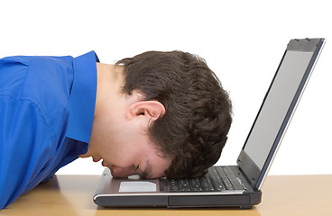 Image showing Man in despair buried head in computer keyboard