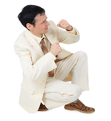 Image showing Businessman sitting in defensive posture