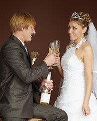 Image showing Newlywed drinking champagne clinking glasses