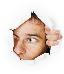 Image showing Man looks through hole