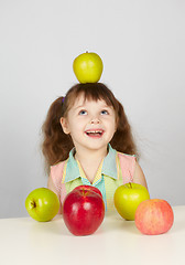 Image showing Apple on head of a cheerful girl