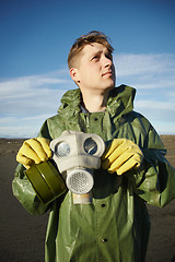 Image showing Young scientist breathe air without gas mask