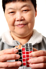 Image showing senior chinese woman playing  rubik cube