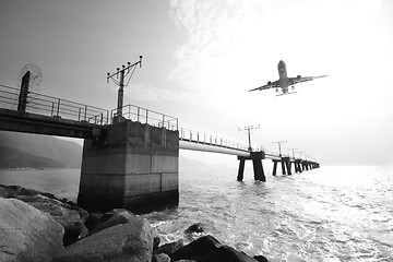 Image showing Plane is going to land in an airport. The plane is a bit in moti