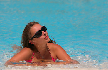 Image showing attractive young woman at a pool 