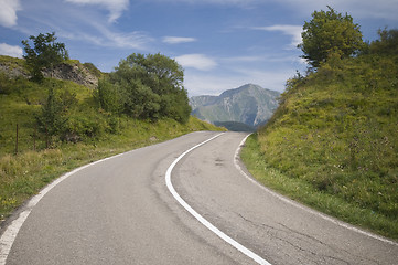 Image showing Winding road leading into mountain valley