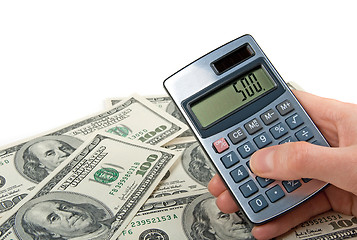 Image showing Money and hand holing a calculator