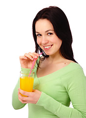 Image showing Young attractive woman drinks orange juice