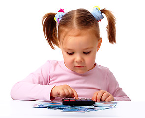 Image showing Little girl plays with money