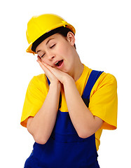 Image showing Young woman in construction uniform is yawning