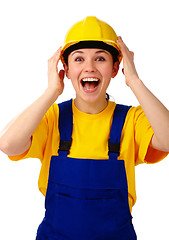Image showing Construction girl holds her hard hat and scream