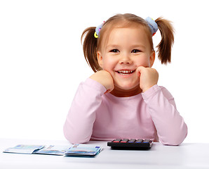 Image showing Little girl with few paper euro banknotes