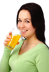 Image showing Young attractive woman drinks orange juice