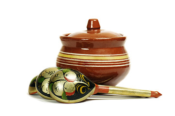 Image showing Clay pot with wooden spoons 