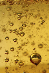 Image showing Air vials in a golden liquid. A background 