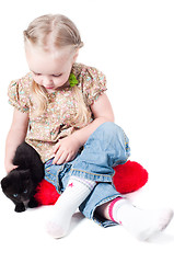 Image showing Little girl playing with kitten