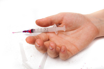 Image showing Syringe in a palm of the addict