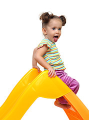 Image showing cute little girl on yellow slide