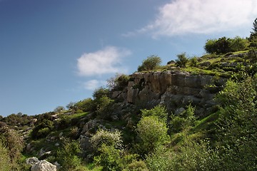 Image showing Steep weathered cliff face in bright spring day