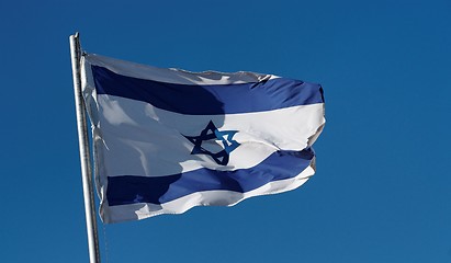 Image showing Israel flag waving in the wind against a blue sky