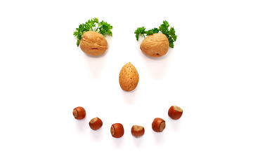 Image showing smiling face made whith help of nuts