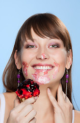 Image showing Happy girl with her face smear in cake