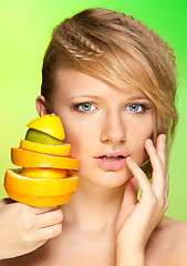 Image showing Face of beautiful woman with pyramid of fruits