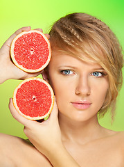 Image showing Portrait of  young attractive woman with grapefruit