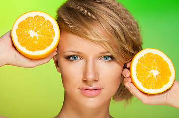 Image showing Juicy oranges and beautiful woman