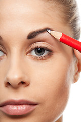 Image showing Pencil woman's eyebrows with a carpenters pen