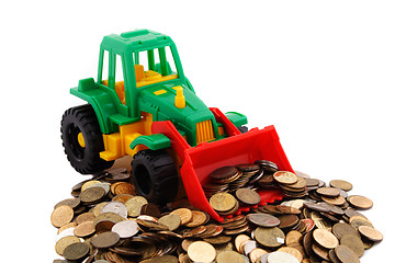 Image showing Gree bulldozer raked pile of coins