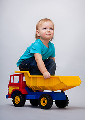 Image showing Kid sitting on a toy truck