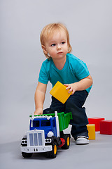 Image showing Kid playing with cars