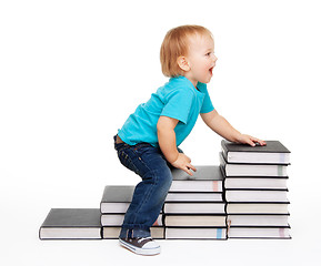 Image showing A kid on a steps of books