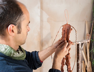 Image showing Artist modeling clay