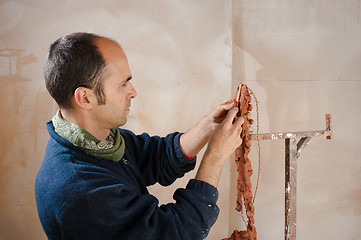 Image showing Artist modeling clay