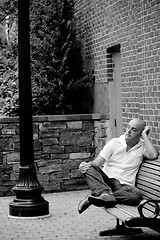 Image showing Casual Guy Sitting on a City Bench