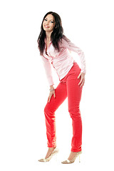 Image showing Smiling brunette in red jeans