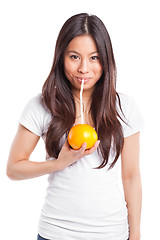 Image showing Asian woman drinking orange juice