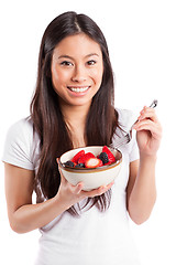 Image showing Asian woman eating fruit