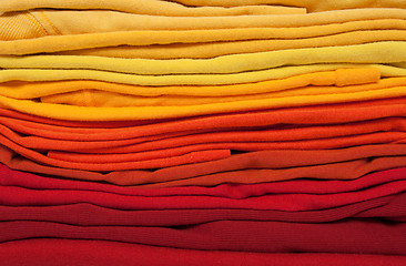 Image showing Folded red, orange and yellow clothes