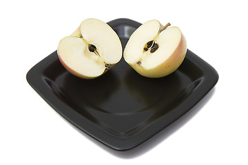 Image showing Two halves of an apple on a plate