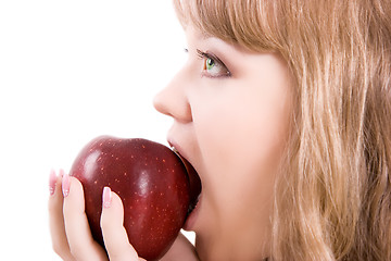 Image showing The girl bites an apple