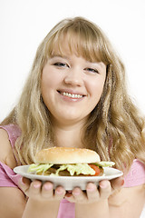 Image showing The young girl with a hamburger