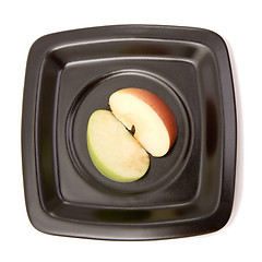 Image showing Two halves of an apple on a plate