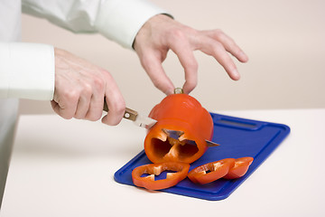 Image showing The man cuts sweet pepper