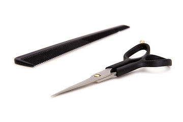 Image showing Hairdresser's scissors and hairbrush