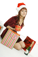 Image showing The girl in a Christmas cap with purchases